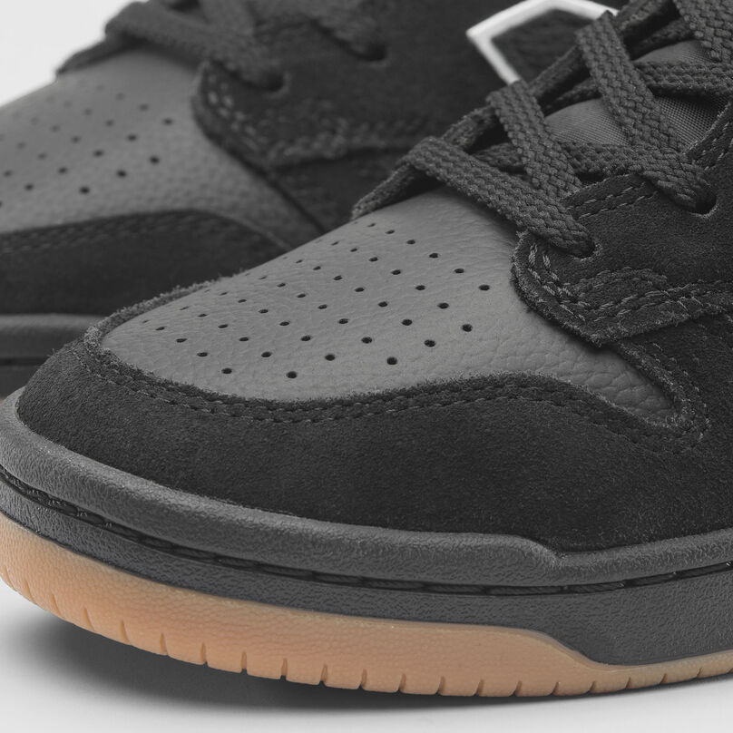 A detail image of a black hightop 480s on a grey background.