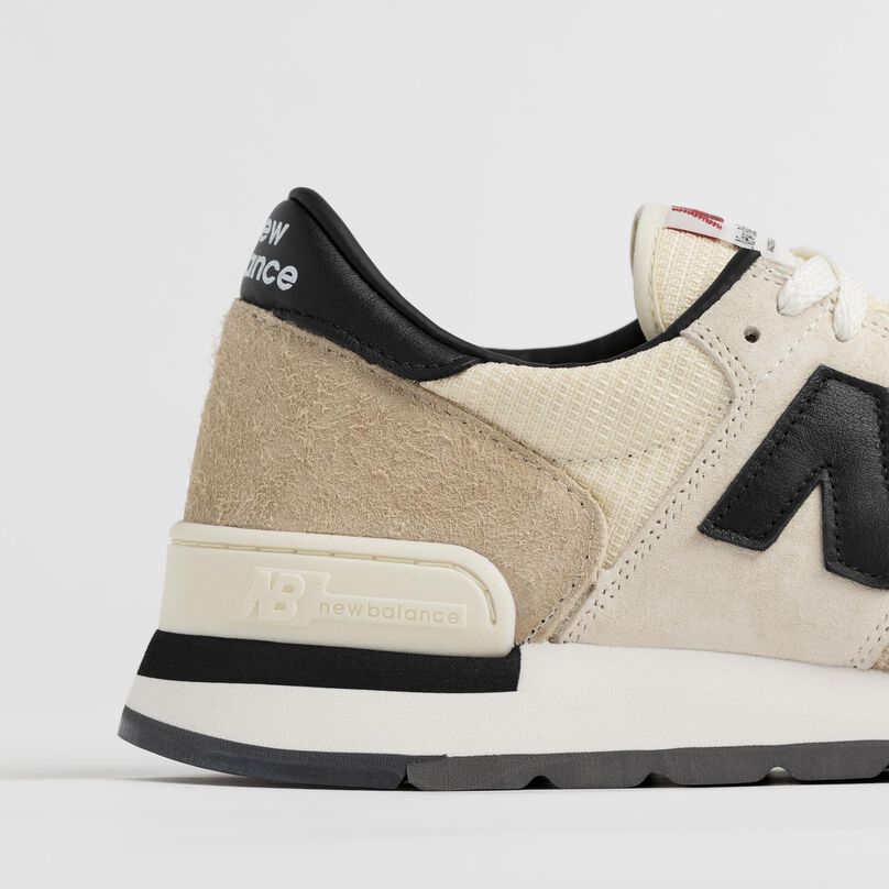 Side detail of the grey 990v1 heel and materials.