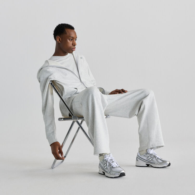 Man sitting on chair wearing New Balance