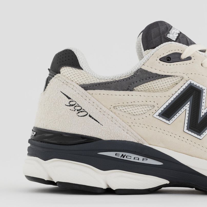 Side detail of the grey 990v1 heel and materials.